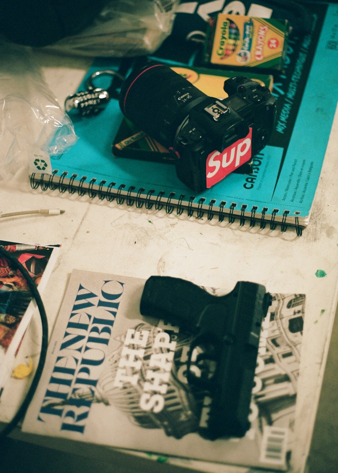 Camera equipment and notebook laid out for a documentary shoot