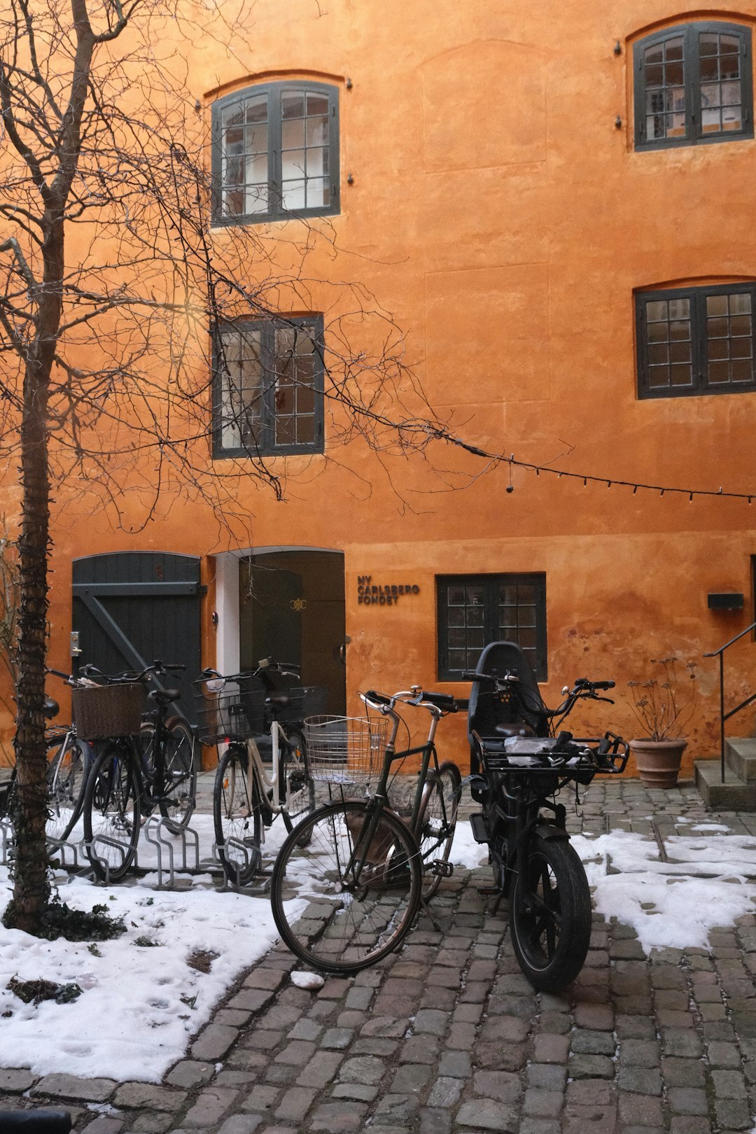 Bicycles parked on a cobblestone street in Copenhagen